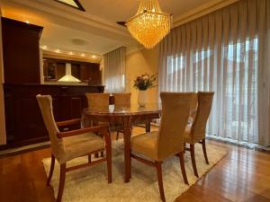 a dining room with a table and chairs and a chandelier at Jackman apartments in Bitola +9 photos