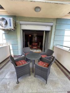 a patio with chairs and a table and a table at Jackman apartments in Bitola