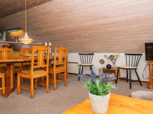 a dining room with a wooden table and chairs at 6 person holiday home in Hvide Sande in Hvide Sande