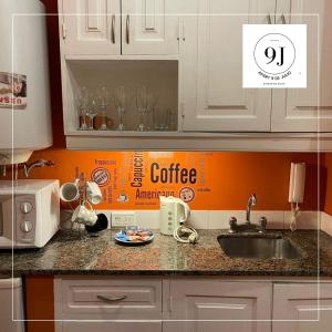 a kitchen counter with a coffee box on the wall at Apart 9 de julio in Salta