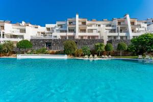 a swimming pool in front of a building at Magnolia Luxury Apartment by AltamarHomes in Adeje