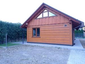 a large wooden garage with a window on it at apartamentyDvorskie in Nowy Sącz