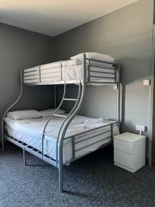 a bedroom with two bunk beds in a room at Sand Beach in Rhyl