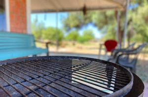 a black table with a bench and a blue bench istg at Hotel Campestre Iparoma in Estancia Campo Aroma