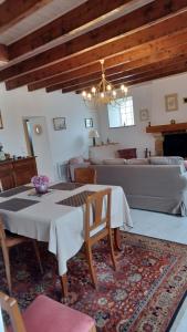 a living room with a table and a couch at La Bretagne ça vous gagne in Ploufragan