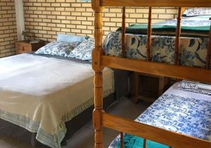 a bedroom with two bunk beds in a room at Paraíso Hostel Praia do Rosa in Praia do Rosa