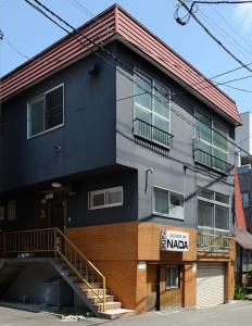 a building with a staircase in front of it at Sapporo Inn Nada in Sapporo