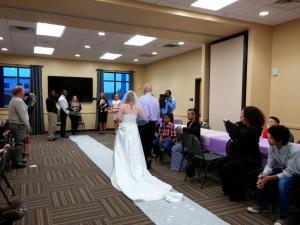a bride walking down the aisle at her wedding at Riverside Inn in Cold Spring