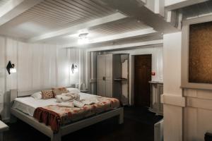 a bedroom with a dog laying on a bed at MicheLLe's in Mizhhirya +40 photos