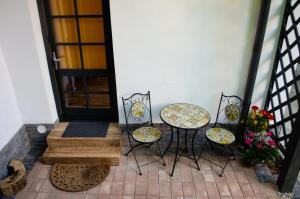 a porch with two chairs and a table and a door at Apartament 42.2 in Bistriţa