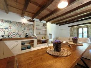 uma sala de estar com uma mesa de madeira com flores em Granja Labrada: Alojamiento con caballos em Mañón