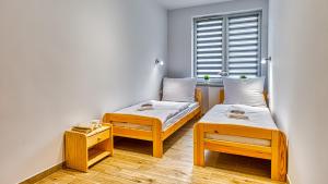 Posteľ alebo postele v izbe v ubytovaní Apartament Angelika B1 - 5D Apartamenty