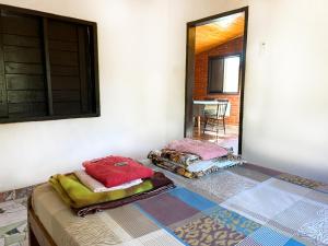 a room with two beds sitting on a floor at Hotel Campestre Iparoma in Estancia Campo Aroma