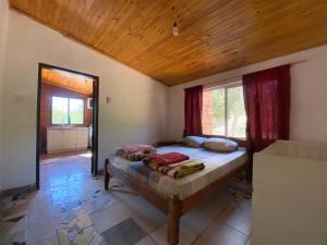 a bedroom with a bed with a wooden ceiling at Hotel Campestre Iparoma in Estancia Campo Aroma