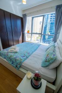 a bedroom with a bed with a large window at Full Apartment in Dubai Marina,80m from beach in Dubai