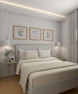 a white bedroom with a large bed and a table at Υπέροχη οικογενειακή κατοικία στον Πειραιά, 3 λεπτά από μετρό in Piraeus