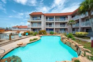 a swimming pool in front of a building at Mystic Harbor 207 in Padre Island