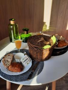 a table with a plate of food and a basket of bread at Le lodge des chênes in Brousses-et-Villaret