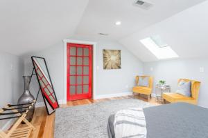 a bedroom with a red door in a white room at Old Lytle Cove Rd - Upper Unit in Swannanoa