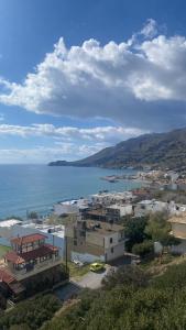 a view of a city and the ocean with buildings at Minoan house in Tsoutsouros +42 photos