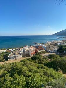 a view of a town and the ocean at Minoan house in Tsoutsouros