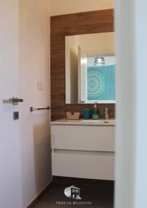a bathroom with a sink and a mirror at TENUTA BILUCCIO B & B in Roccadaspide