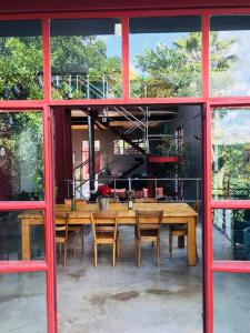 a dining room with a wooden table and chairs at (Sub)urban retreat in Johannesburg