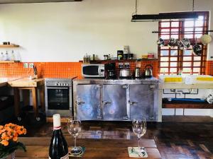 a kitchen with two wine glasses on a table at (Sub)urban retreat in Johannesburg