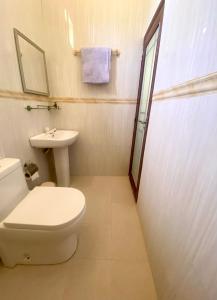 a bathroom with a toilet and a sink at Sands Inn, Mathiveri in Mathiveri