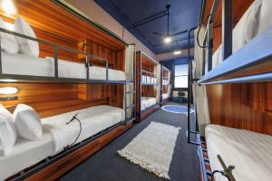 a room with three bunk beds in a boat at Roamer St Kilda - formerly Selina St Kilda Melbourne in Melbourne