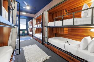 a room with four bunk beds in a house at Roamer St Kilda - formerly Selina St Kilda Melbourne in Melbourne