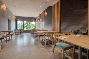 a dining room with wooden tables and chairs at Hotel Villa Barbara in Neum