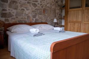 a bedroom with a bed with towels on it at House Antica in Lastovo