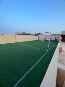 a tennis court on the roof of a building at Al Shiya Chalet in Sur