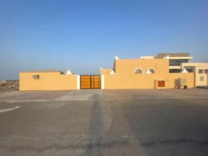 a large parking lot in front of some buildings at Al Shiya Chalet in Sur