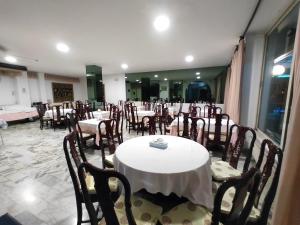 a group of tables and chairs in a restaurant at Hotel Sorriso in Sanremo