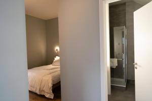 a bedroom with a bed and a glass door at The Layhead B&B in Lübeck