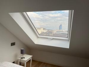 a bedroom with a window with a view of a city at Ruhrgebiet-Apartments in Duisburg Stadtmitte in Duisburg