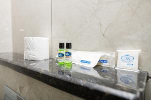 a counter in a bathroom with toiletries on it at KK Comforts in Shrīrangapattana