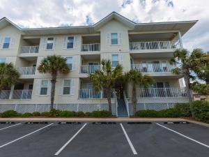 a large apartment building with a parking lot at Gulf Island #521 in Navarre
