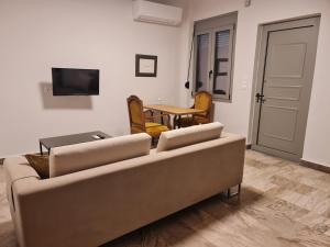 a living room with a couch and a table at Sarri Appartments in Amoudara Herakliou