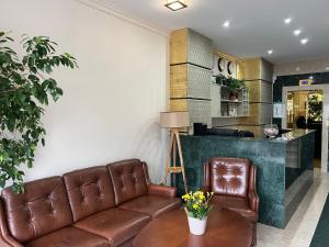 a living room with a couch and a table at Hotel 007 in Sofia