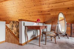 a wooden room with a desk and a mirror at Quaint Riverfront Barn in Kankakee