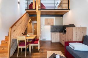 a kitchen and a living room with a loft at Hohenegg Apartment Franz 1 in Campolasta