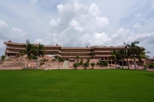 a large building with a green field in front of it at Lake View Hotel and Resort in Jodhpur