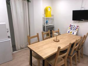 a dining room with a wooden table and chairs at Chris Hostel in Seoul