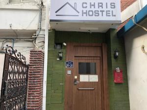 un edificio con una puerta de madera y un cartel en él en Chris Hostel, en Seúl