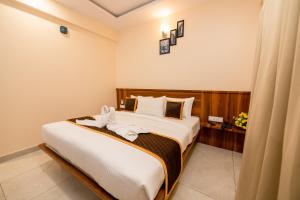 a bedroom with a large bed in a room at KK Comforts in Shrīrangapattana