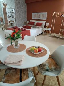 a living room with a white table with fruit on it at Villa Sant'Andrea in Trecastagni