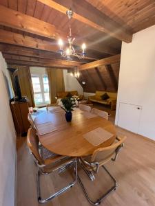 a dining room with a wooden table and chairs at Get Cozy Flat Zürich in Zürich